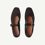 A pair of Mary Jane Woven Leather Shoes in black handwoven goatskin, featuring a classic buckle strap and shown from above on a white background.