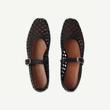 A pair of Mary Jane Woven Leather Shoes in black handwoven goatskin, featuring a classic buckle strap and shown from above on a white background.