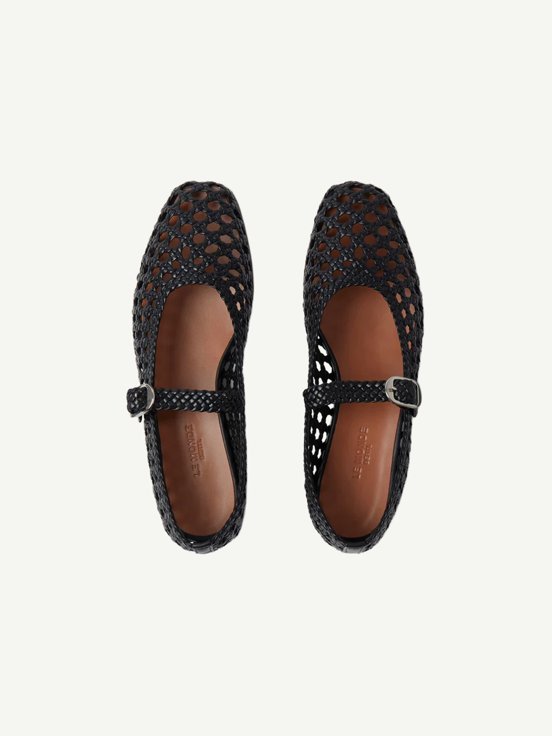 A pair of Mary Jane Woven Leather Shoes in black handwoven goatskin, featuring a classic buckle strap and shown from above on a white background.