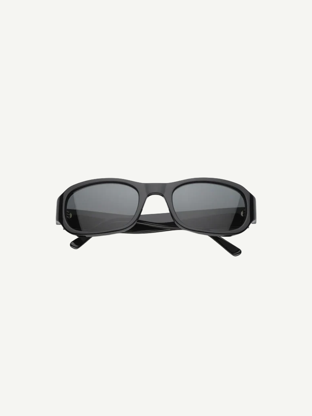 Jordyn rectangular black sunglasses with dark lenses, shown from the front against a plain white background. The crossed arms at the back add style, while Jordyn offers reliable UV protection for sunny days—perfect festival sunglasses.