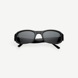 Jordyn rectangular black sunglasses with dark lenses, shown from the front against a plain white background. The crossed arms at the back add style, while Jordyn offers reliable UV protection for sunny days—perfect festival sunglasses.