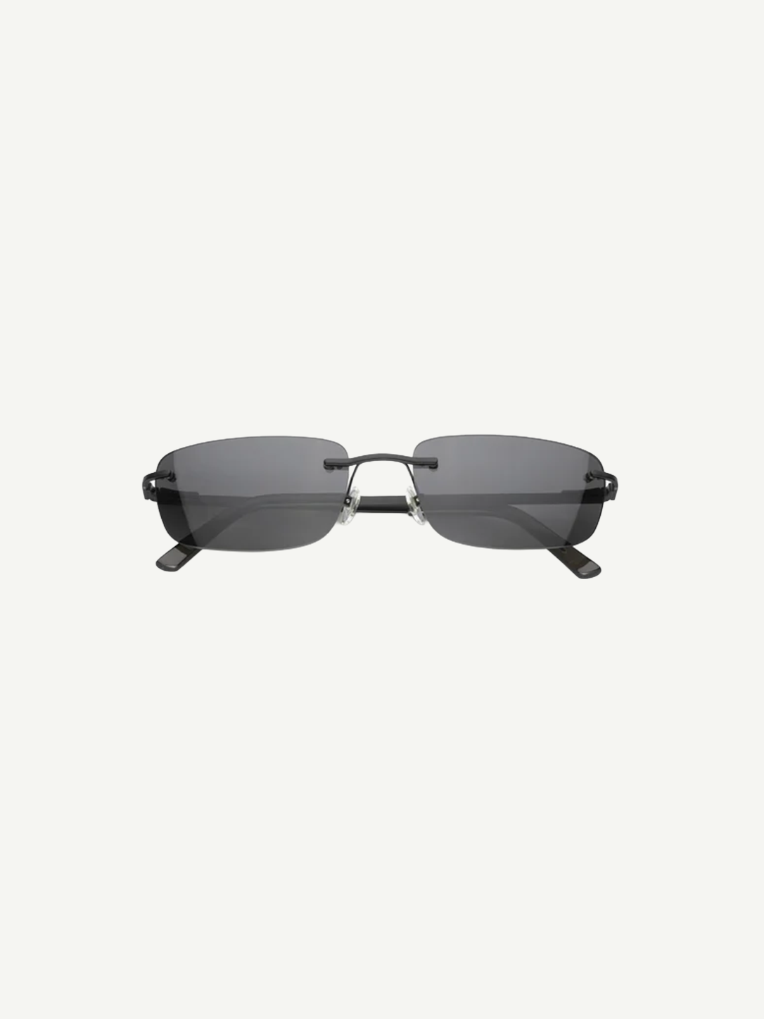 Paris sunglasses feature a rimless rectangle design with dark gray lenses and thin black arms, displayed against a plain white background. Inspired by iconic 2000s style, Paris offers reliable UV protection for everyday wear.
