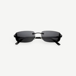 Paris sunglasses feature a rimless rectangle design with dark gray lenses and thin black arms, displayed against a plain white background. Inspired by iconic 2000s style, Paris offers reliable UV protection for everyday wear.