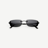 Paris sunglasses feature a rimless rectangle design with dark gray lenses and thin black arms, displayed against a plain white background. Inspired by iconic 2000s style, Paris offers reliable UV protection for everyday wear.