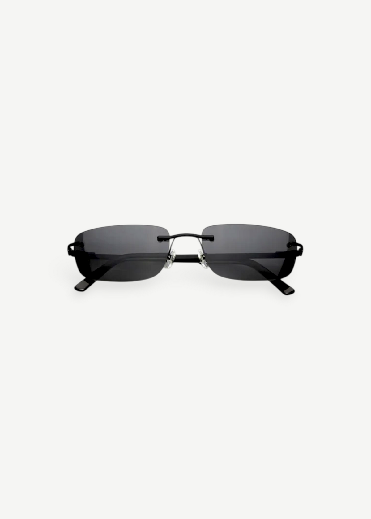 Paris sunglasses feature a rimless rectangle design with dark gray lenses and thin black arms, displayed against a plain white background. Inspired by iconic 2000s style, Paris offers reliable UV protection for everyday wear.