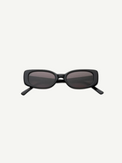 The Solene sunglasses feature a black slim rectangular frame with dark tinted lenses that provide 100% UV protection, displayed front-facing against a plain white background.