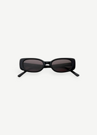 The Solene sunglasses feature a black slim rectangular frame with dark tinted lenses that provide 100% UV protection, displayed front-facing against a plain white background.