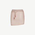 The Lumiere Skirt is a pale pink textured mini skirt featuring a matching waist tie with three round beads on each end and delicate sequin bead accents, shown against a plain white background.