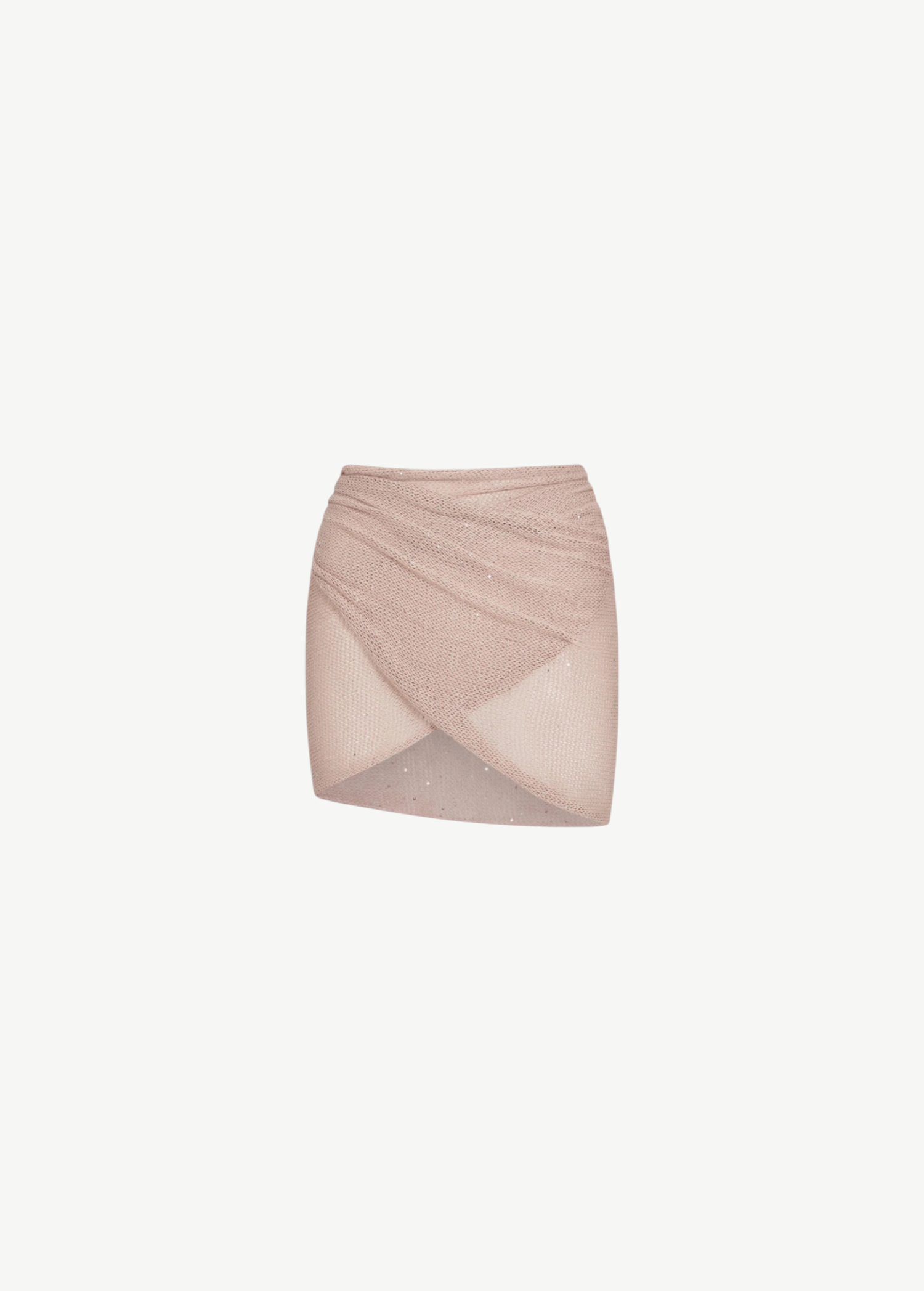 The Lumiere Skirt is a light pink, textured knit mini skirt with a criss-cross, wrap-style front and subtle sparkle details, featuring sequin bead accents for added shimmer, isolated on a white background.