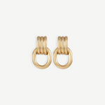 Elsa Earrings feature a pierced back and three rounded gold-plated bars stacked above a thick, oval-shaped loop, shown against a plain white background. Crafted with 14KT gold plating, these earrings are stylish, lightweight, and ideal for everyday wear.