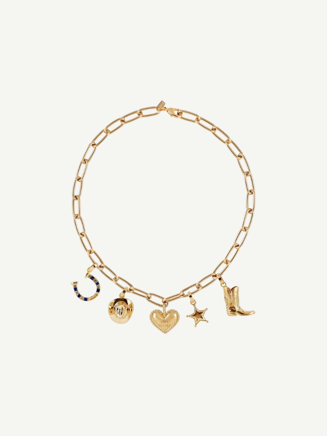 The Most Wanted Necklace, a gold chain adorned with five distinctive charms—a horseshoe, round locket, textured heart, star, and cowboy boot—showcases Western-inspired style on a white background.