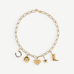 The Most Wanted Necklace, a gold chain adorned with five distinctive charms—a horseshoe, round locket, textured heart, star, and cowboy boot—showcases Western-inspired style on a white background.