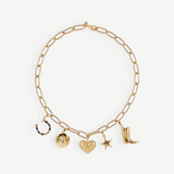 The Most Wanted Necklace, a gold chain adorned with five distinctive charms—a horseshoe, round locket, textured heart, star, and cowboy boot—showcases Western-inspired style on a white background.
