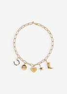The Most Wanted Necklace, a gold chain adorned with five distinctive charms—a horseshoe, round locket, textured heart, star, and cowboy boot—showcases Western-inspired style on a white background.