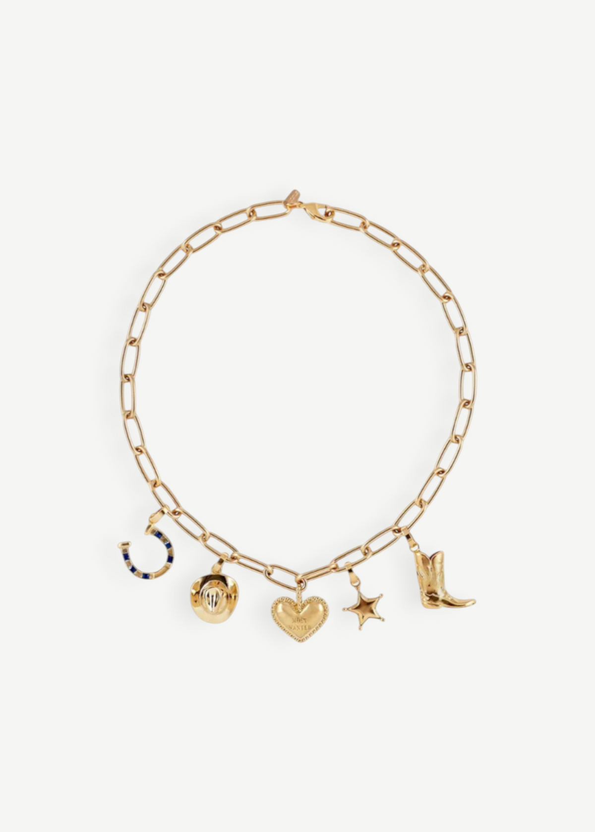 The Most Wanted Necklace, a gold chain adorned with five distinctive charms—a horseshoe, round locket, textured heart, star, and cowboy boot—showcases Western-inspired style on a white background.
