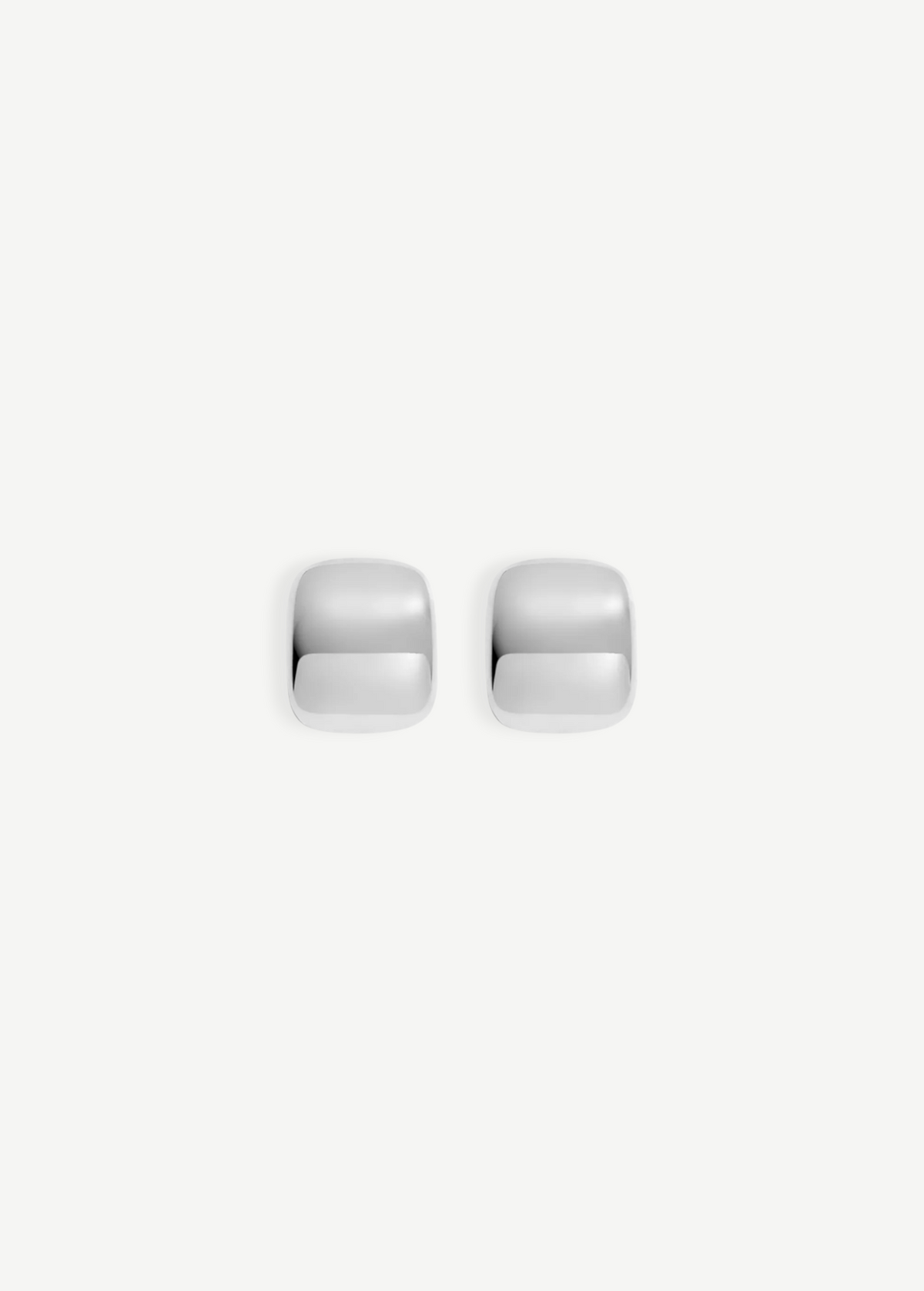 Two small, shiny Pebble Earrings with a square shape and rounded edges are placed side by side on a plain white background. Each earring measures approximately 1 inch in length and features a lustrous rhodium plate finish.