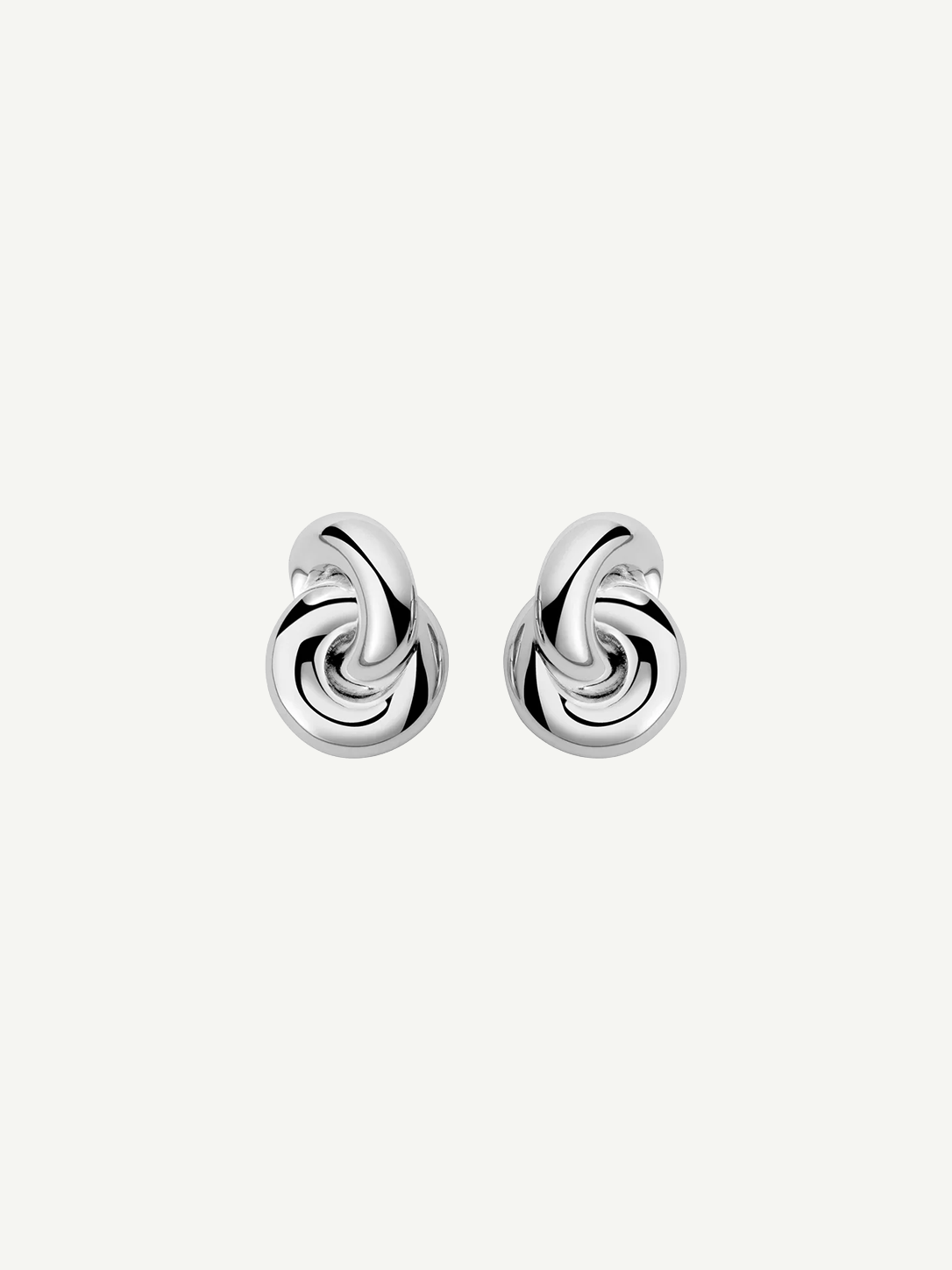 The Rhodium Amina Earrings are featured on a plain white background, showcasing an intricate interwoven knot design with a polished, shiny finish and a secure pierced back.