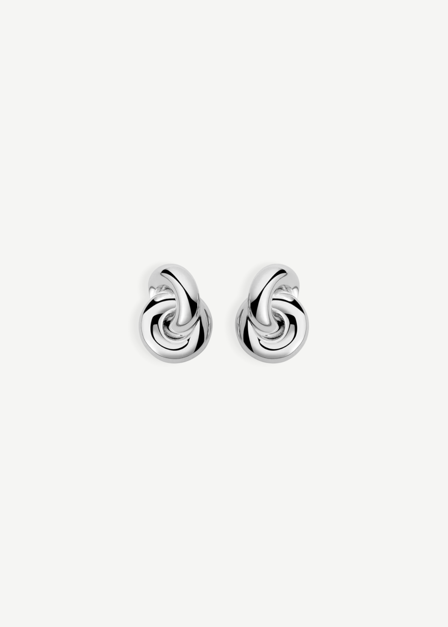 The Rhodium Amina Earrings are featured on a plain white background, showcasing an intricate interwoven knot design with a polished, shiny finish and a secure pierced back.