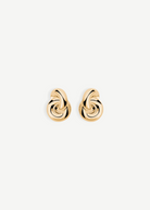 The Amina Earrings are displayed on a plain white background. These elegant earrings feature a gold-plated, intertwined looped design with a smooth, polished finish and a classic pierced back for secure wear.