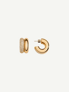 Introducing the CZ Double Hoop Earrings: a pair of elegant 14KT gold-plated double hoops, featuring one side exquisitely encrusted with pave cubic zirconia for added brilliance. One earring is showcased from the front to highlight its captivating sparkle, while the other is displayed from the side to reveal the sleek post and secure clasp.