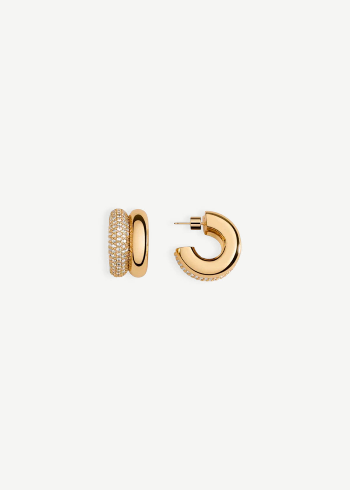 Introducing the CZ Double Hoop Earrings: a pair of elegant 14KT gold-plated double hoops, featuring one side exquisitely encrusted with pave cubic zirconia for added brilliance. One earring is showcased from the front to highlight its captivating sparkle, while the other is displayed from the side to reveal the sleek post and secure clasp.