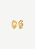 A pair of Donut Pierced Hoops, small and chunky gold earrings crafted from 14kt gold plate with a 1-inch diameter, displayed against a plain white background.