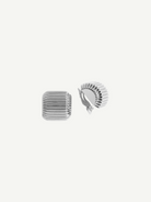 Presenting the Elle Earrings: a pair of silver, square-shaped clip-on earrings featuring grooved, ridged surfaces and a luxurious 14KT gold plate accent. One earring is displayed from the front and the other from the back to highlight the secure clip mechanism, all set against a plain white background.