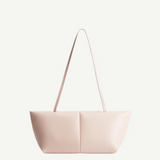 The Boulevard Sling Bag is a light pink, minimalist padded handbag featuring two symmetrical panels and thin straps, displayed on a plain white background.