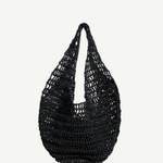 The Market Net Bag is a black, hand-crocheted shoulder bag featuring an open, net-like pattern and a rounded shape, shown against a plain white background.