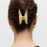 KABE SHOP INC Midi Heirloom hair claw in cream Italian acetate worn in a bun on a woman with gold hoop earrings