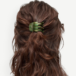 KABE SHOP INC mini claw hair clip in green striped Italian bio-acetate worn in wavy brown hair