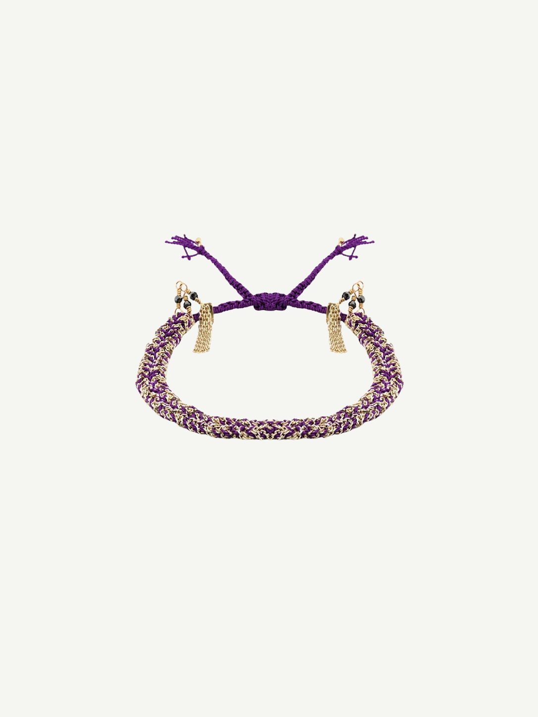 Introducing the N° 183 Braided Bracelet: this adjustable, handcrafted piece features purple and gold braiding with elegant gold chain tassels at each end. Shown against a white backdrop, it’s a versatile accessory—ideal for daily wear or as a thoughtful gift.