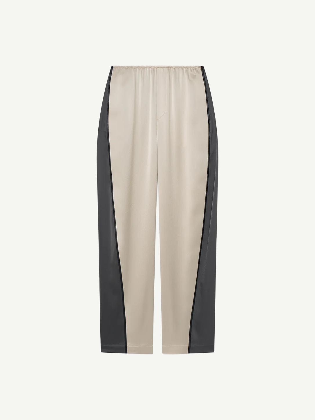 Beige Zoela Pants featuring black side panels, an elastic waistband, and a relaxed, wide barrel-leg silhouette, showcased against a plain white background.