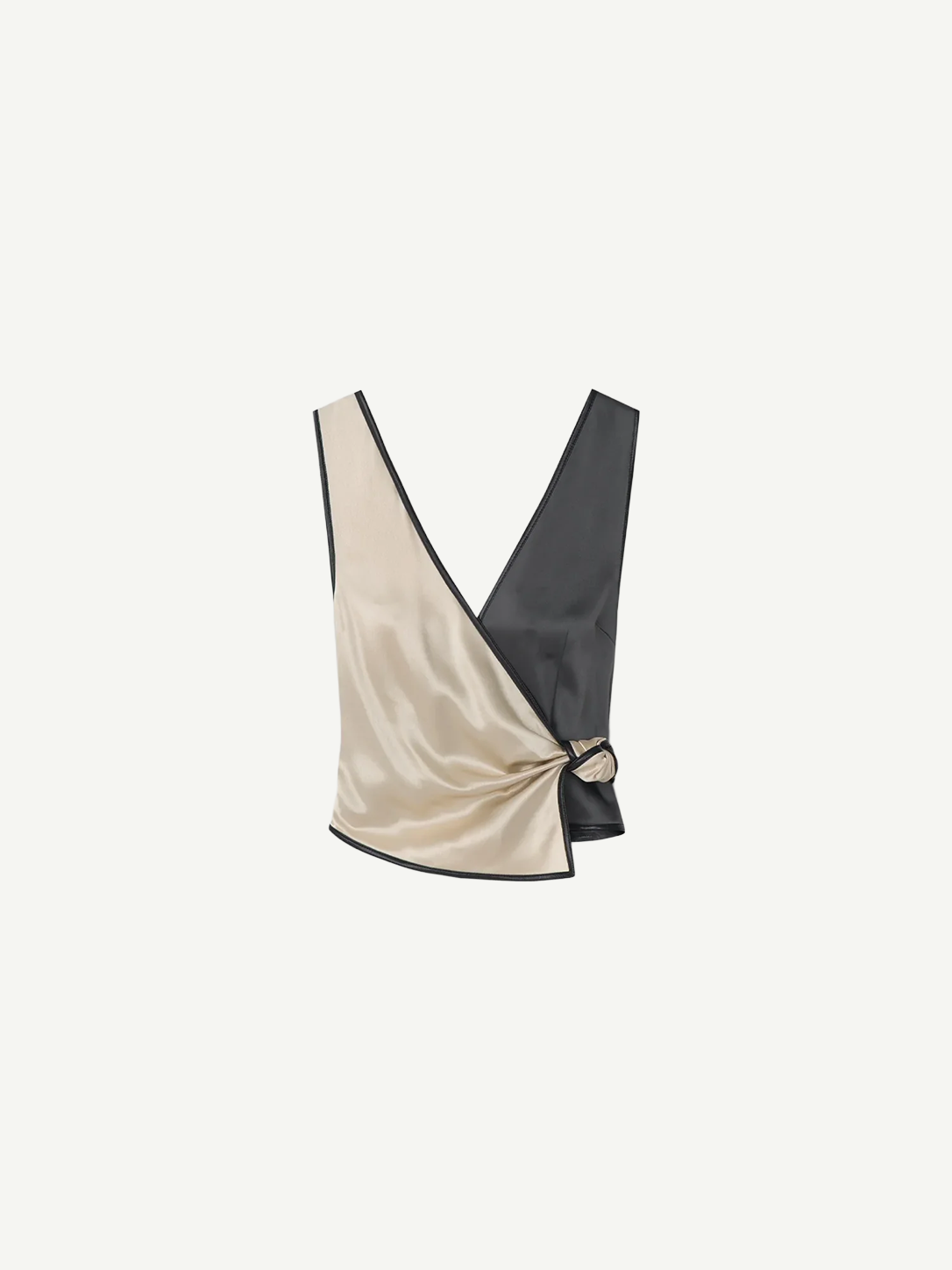 Introducing the Aisling Top: a sleeveless, color-block design crafted from luxurious slip satin. This top features a deep V-neckline, with the left half in striking beige and the right half in bold black, elegantly finished with a knot detail at the side.