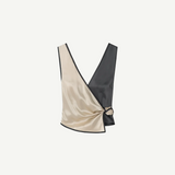 Introducing the Aisling Top: a sleeveless, color-block design crafted from luxurious slip satin. This top features a deep V-neckline, with the left half in striking beige and the right half in bold black, elegantly finished with a knot detail at the side.