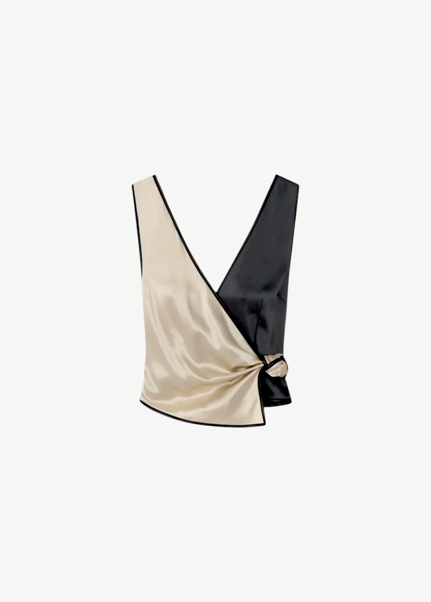 Introducing the Aisling Top: a sleeveless, color-block design crafted from luxurious slip satin. This top features a deep V-neckline, with the left half in striking beige and the right half in bold black, elegantly finished with a knot detail at the side.