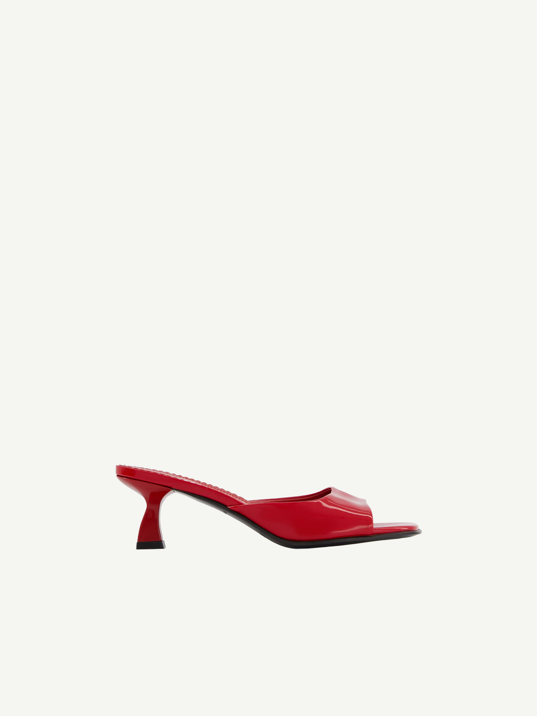 The Dona Mule is a red, open-toe heeled mule pump featuring a sleek design, low curved heel, and glossy finish, expertly crafted in Italy and showcased against a plain white background.