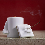KABE SHOP INC Oh Mon Dieu! white porcelain incense holder and candle featuring sculptural lips and nose design.