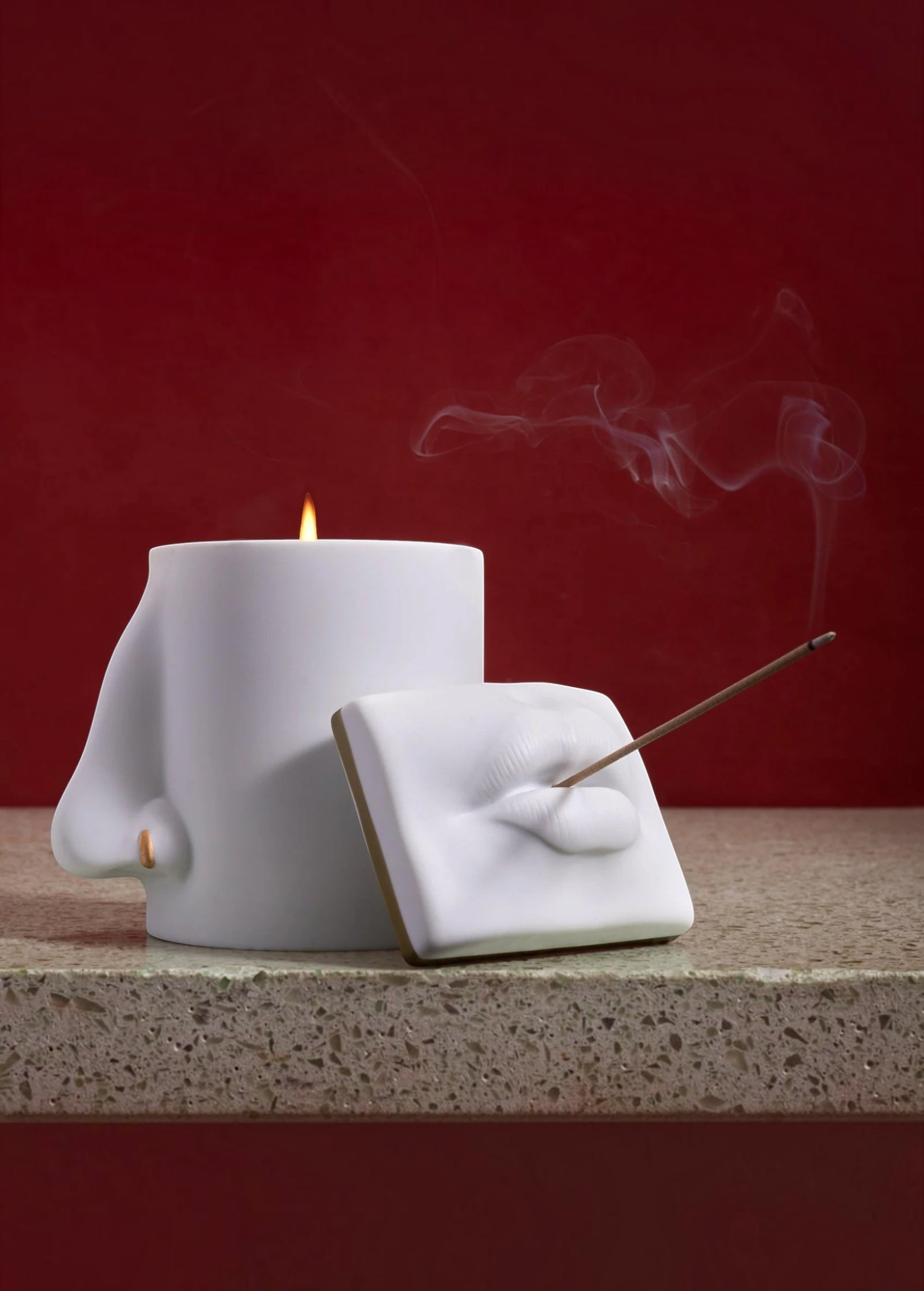 KABE SHOP INC Oh Mon Dieu! white porcelain incense holder and candle featuring sculptural lips and nose design.