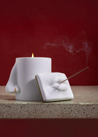 KABE SHOP INC Oh Mon Dieu! white porcelain incense holder and candle featuring sculptural lips and nose design.
