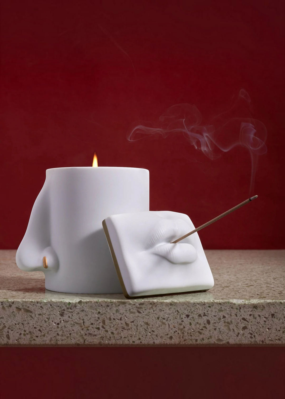 KABE SHOP INC Oh Mon Dieu! white porcelain incense holder and candle featuring sculptural lips and nose design.