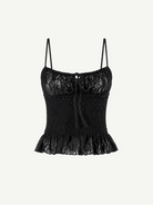 Introducing the Slip Top: a black lace camisole featuring adjustable shoulder straps, a ruched bodice, and a ruffled hem. This elegant Slip Top showcases a decorative bow at the neckline and a delicate floral lace pattern—perfect for pairing with ruffle pants or your favorite jeans.