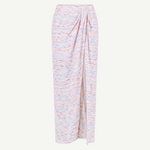 The Sarong Skirt is a long, high-waisted piece with a pastel multicolor speckled pattern. It features a straight silhouette, ankle-length hem, and is accented by a side drape and gathered waist detail—perfect for effortless beachwear.