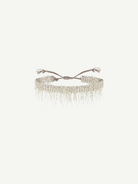 N° 675 Silver Bracelet featuring a delicate design with dangling chain fringe and an adjustable braided clasp, offering a subtle touch perfect for everyday wear, displayed against a plain white background.