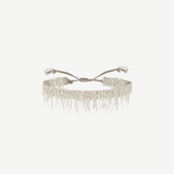 N° 675 Silver Bracelet featuring a delicate design with dangling chain fringe and an adjustable braided clasp, offering a subtle touch perfect for everyday wear, displayed against a plain white background.
