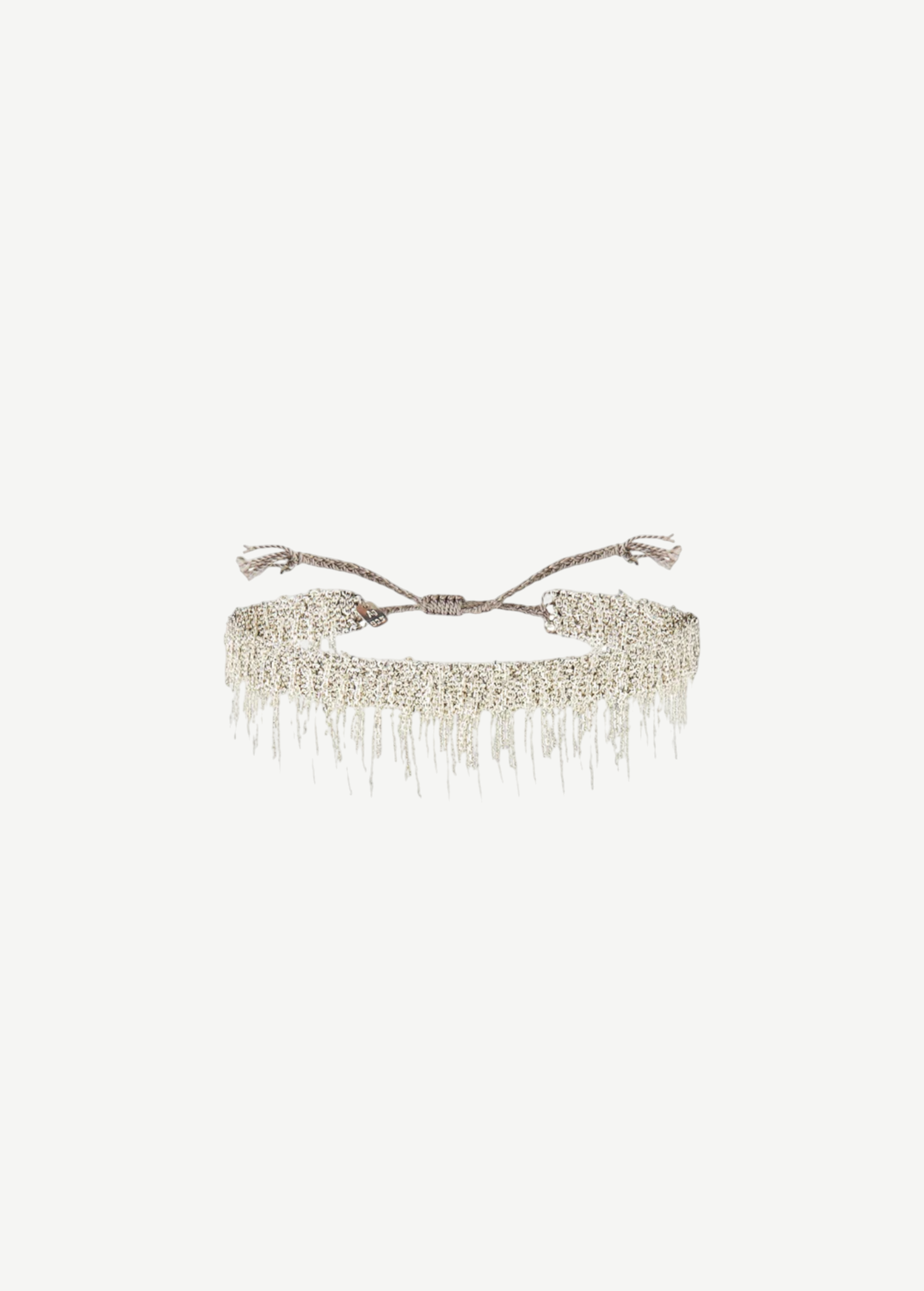 N° 675 Silver Bracelet featuring a delicate design with dangling chain fringe and an adjustable braided clasp, offering a subtle touch perfect for everyday wear, displayed against a plain white background.