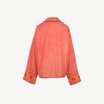 Back view of the Poppy Shirt, a coral pink embroidered jacket featuring wide sleeves, orange and yellow geometric embroidery on the cuffs, and matching trim along the edges. Dry clean only.