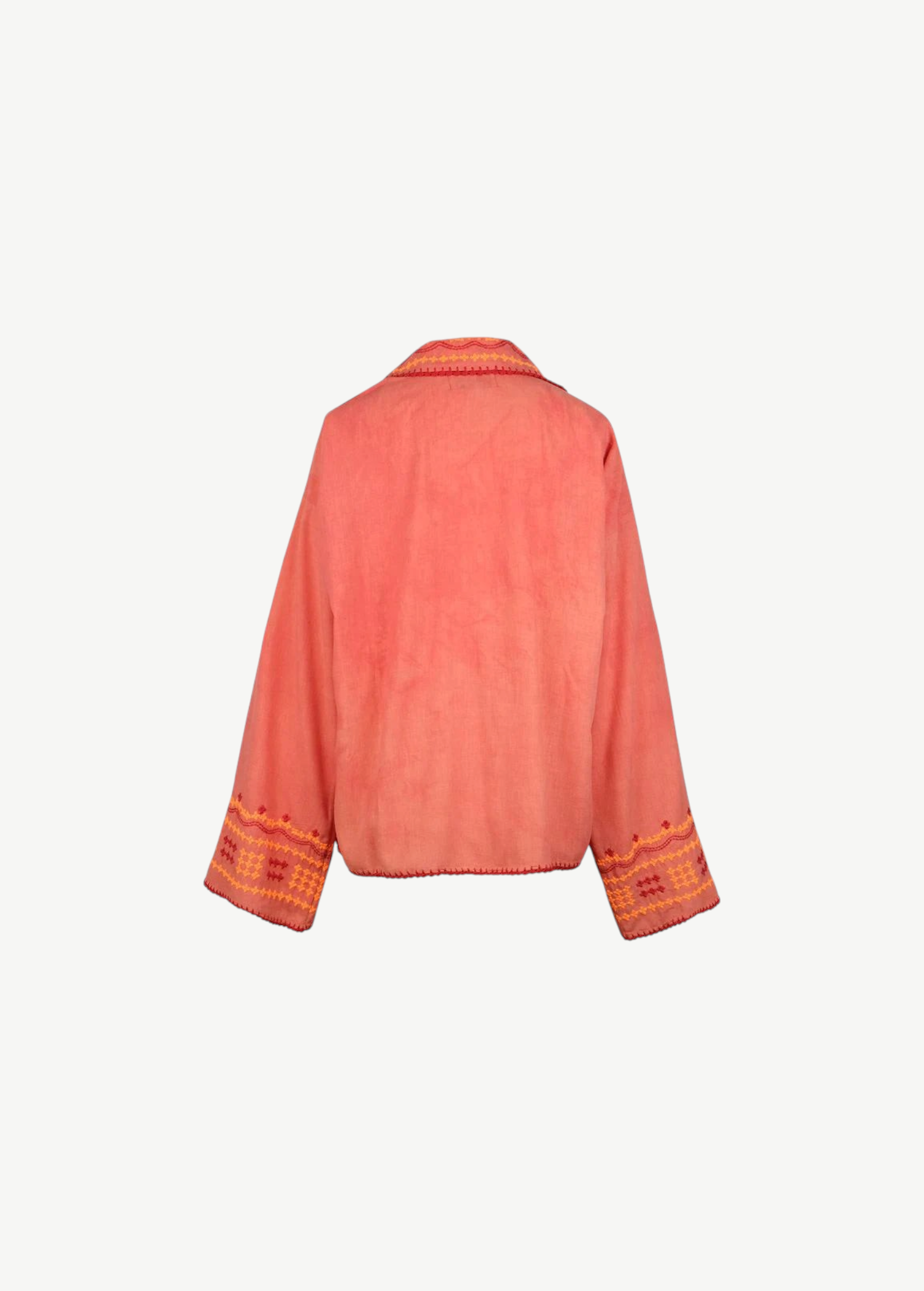 Back view of the Poppy Shirt, a coral pink embroidered jacket featuring wide sleeves, orange and yellow geometric embroidery on the cuffs, and matching trim along the edges. Dry clean only.