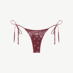 Praia Bottom—maroon bikini bottom with a white paisley bandana print, crafted from eco terry fabric and featuring adjustable side tie straps—displayed on a white background.
