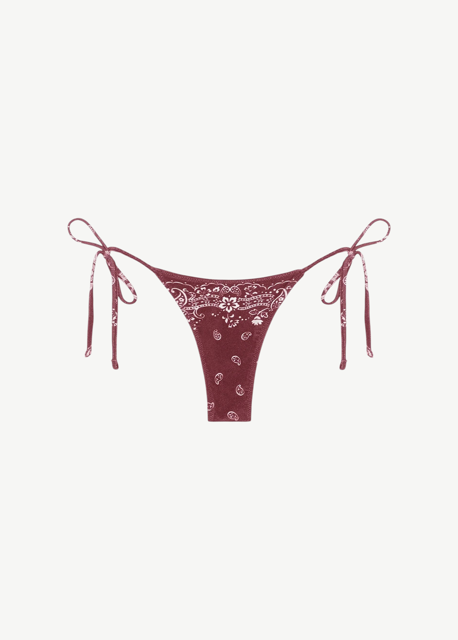 Praia Bottom—maroon bikini bottom with a white paisley bandana print, crafted from eco terry fabric and featuring adjustable side tie straps—displayed on a white background.